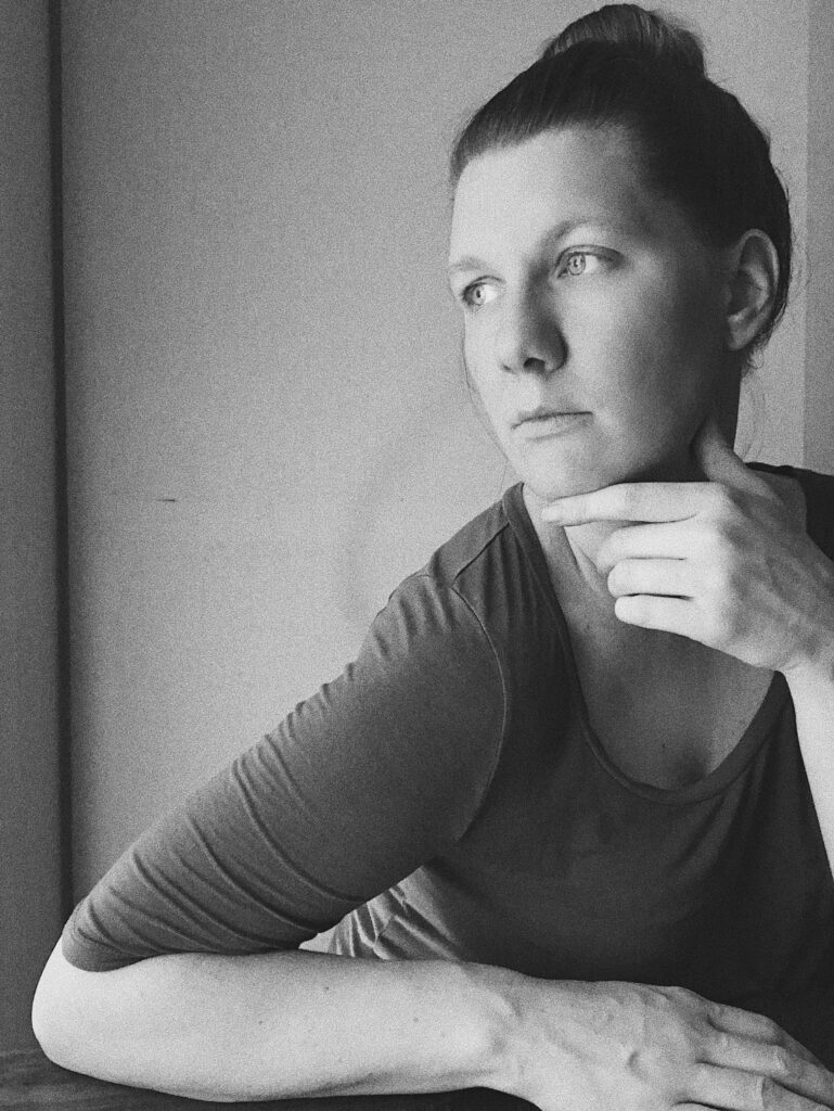 black and white image of a woman looking to the left, thoughtfully.